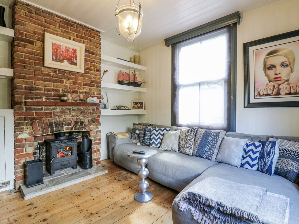 A living room with a brick wall and fireplace at 14 Marine Terrace in Whitstable