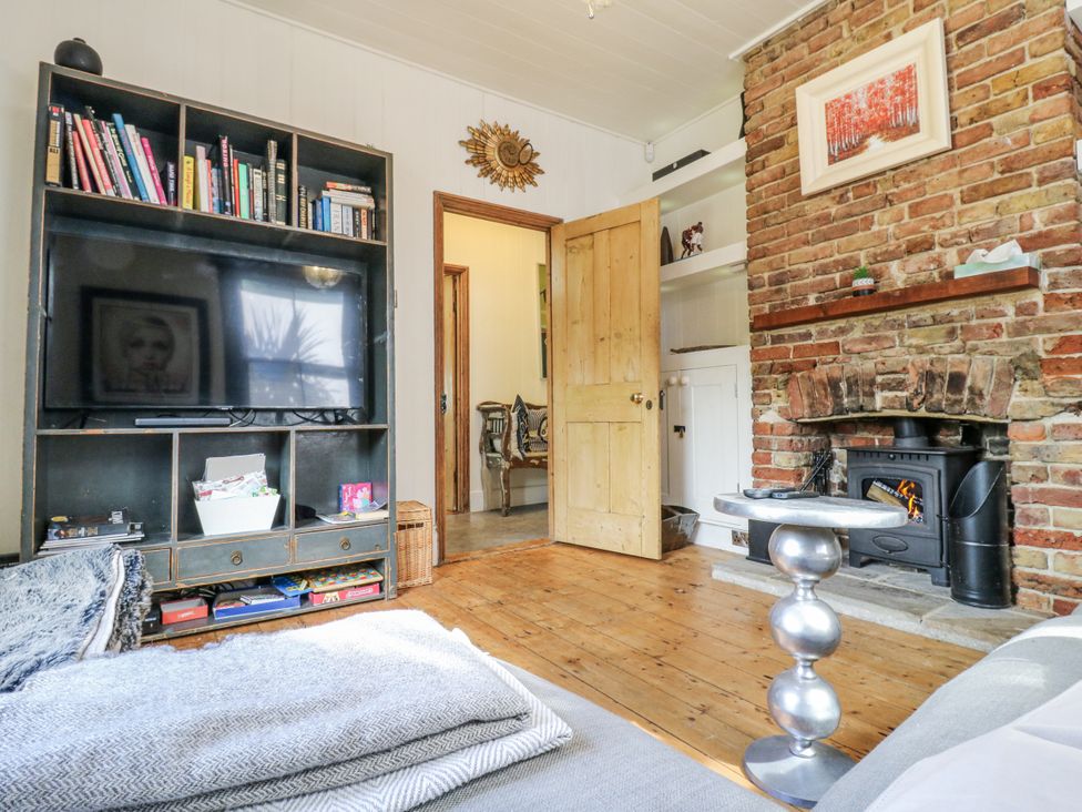 A living room with a television and bookshelf at 14 Marine Terrace in Whitstable