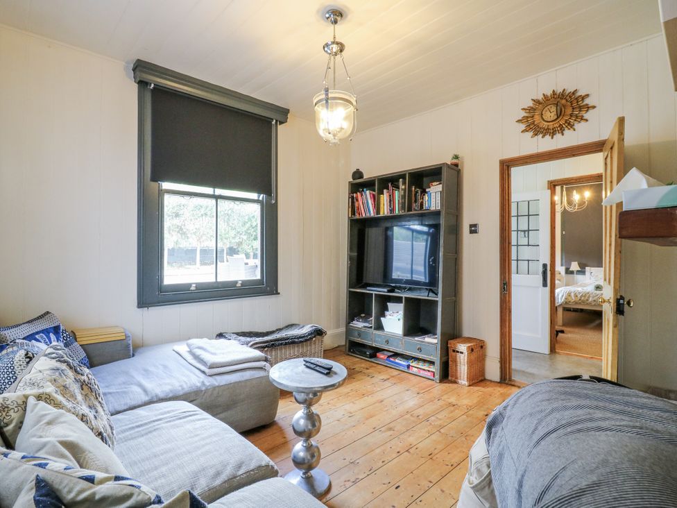 A living room with a sofa and bookshelf at 14 Marine Terrace in Whitstable