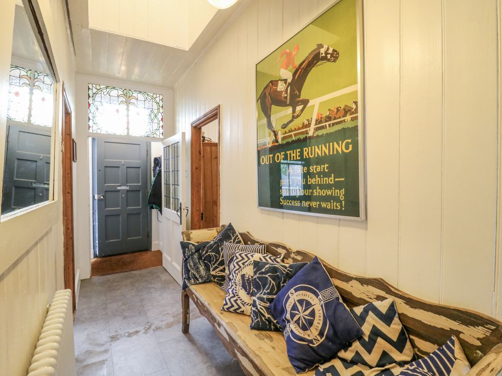 A hallway with a bench and cushions at 14 Marine Terrace Whitstable