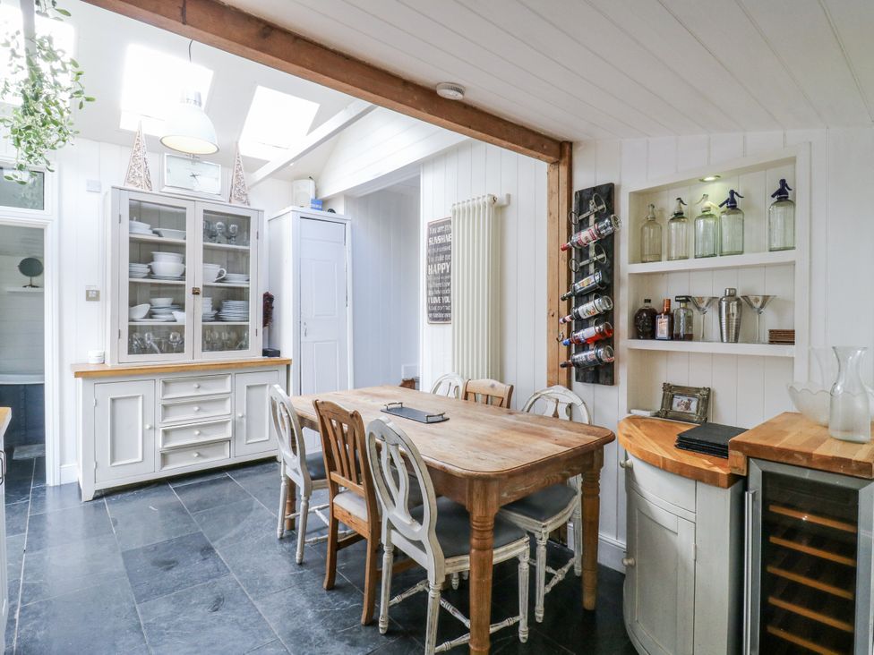 A kitchen with a wooden table and chairs at 14 Marine Terrace in Whitstable