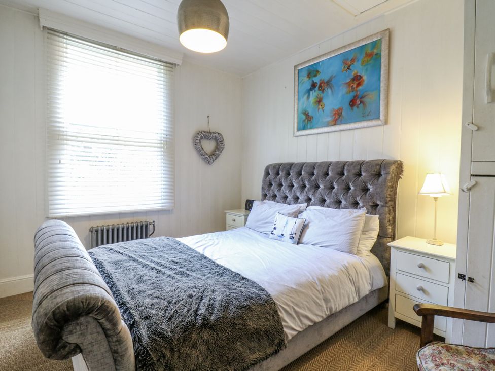 A bedroom with a bed and bedside table at 14 Marine Terrace Whitstable