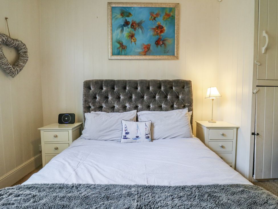 A bedroom with a bed and nightstand at 14 Marine Terrace in Whitstable