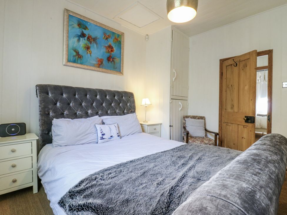 A bedroom with a bed and bedside table at 14 Marine Terrace, Whitstable