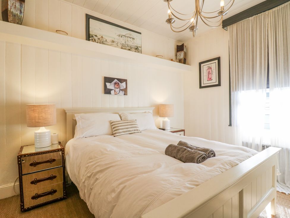 A bedroom with a bed and bedside table at 14 Marine Terrace in Whitstable