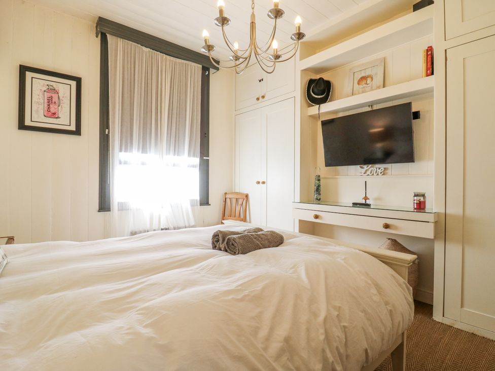 A bedroom with a bed and television at 14 Marine Terrace in Whitstable