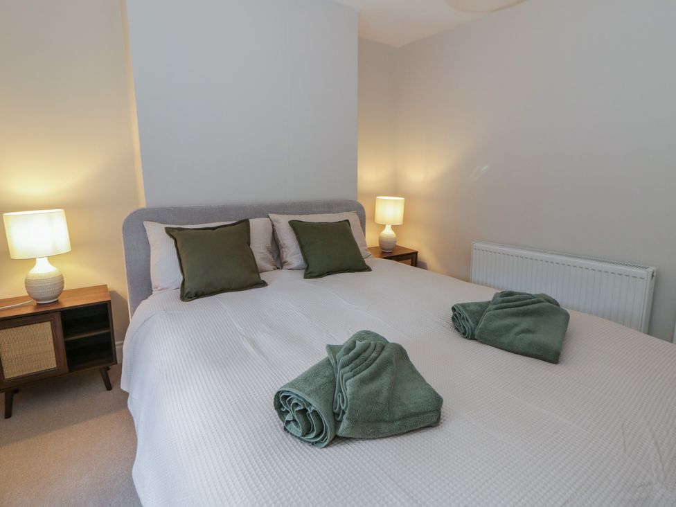 A bedroom with a bed and lamps at Cariad Cottage in Hereford