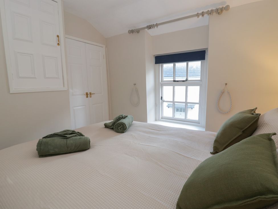 A bedroom with a bed and towels at Cariad Cottage Hereford