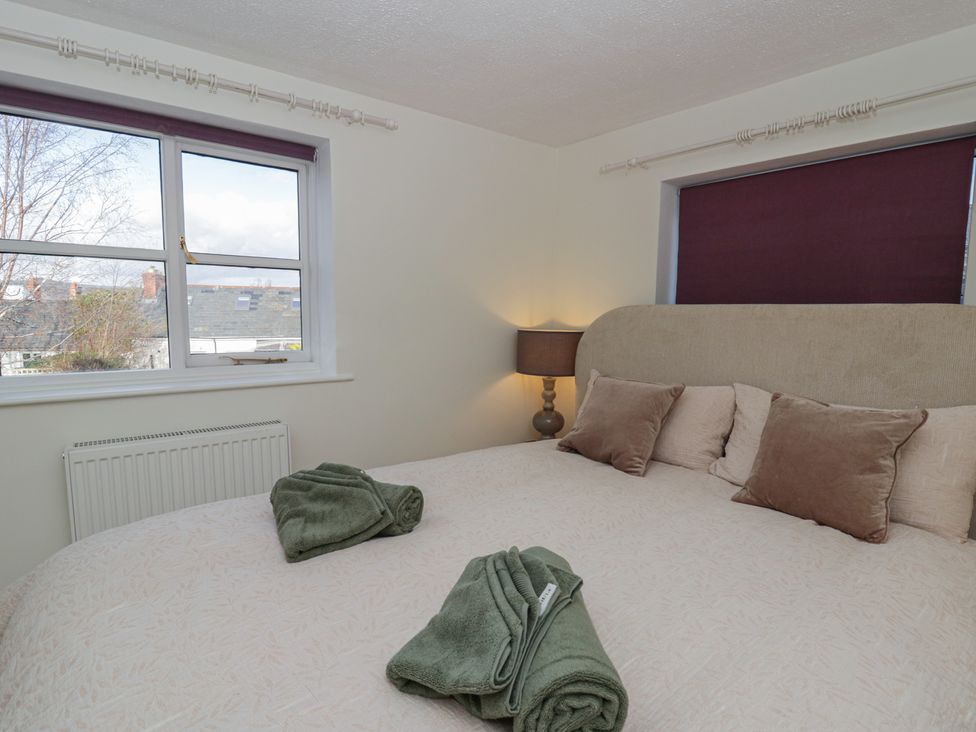 A bedroom with a bed and lamp at Cariad Cottage Hereford