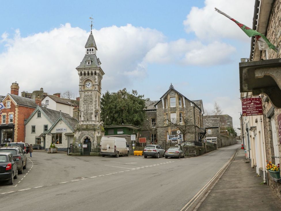 A street view featuring a clock tower and buildings at Cariad Cottage in Hereford
