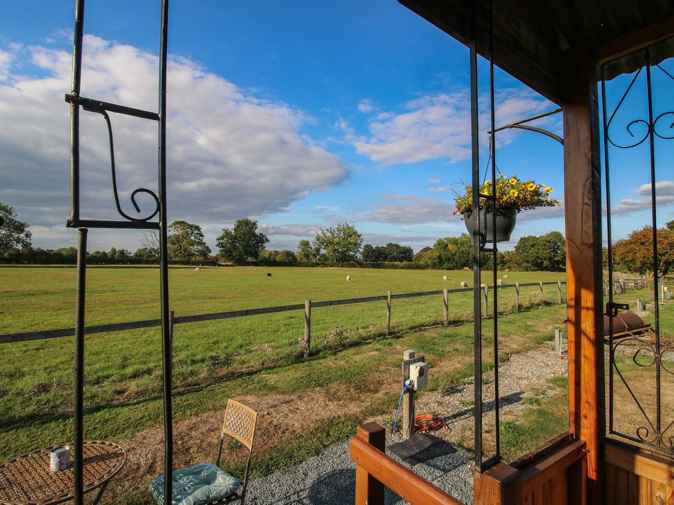 A view of a field and fence from a hut at Sharon's Shepherd Hut Oswestry