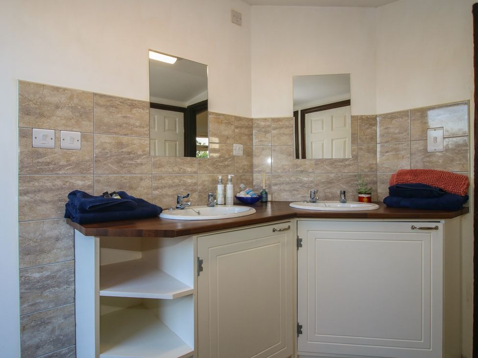 A bathroom with double sinks and cabinets at Sharon's Shepherd Hut in Oswestry