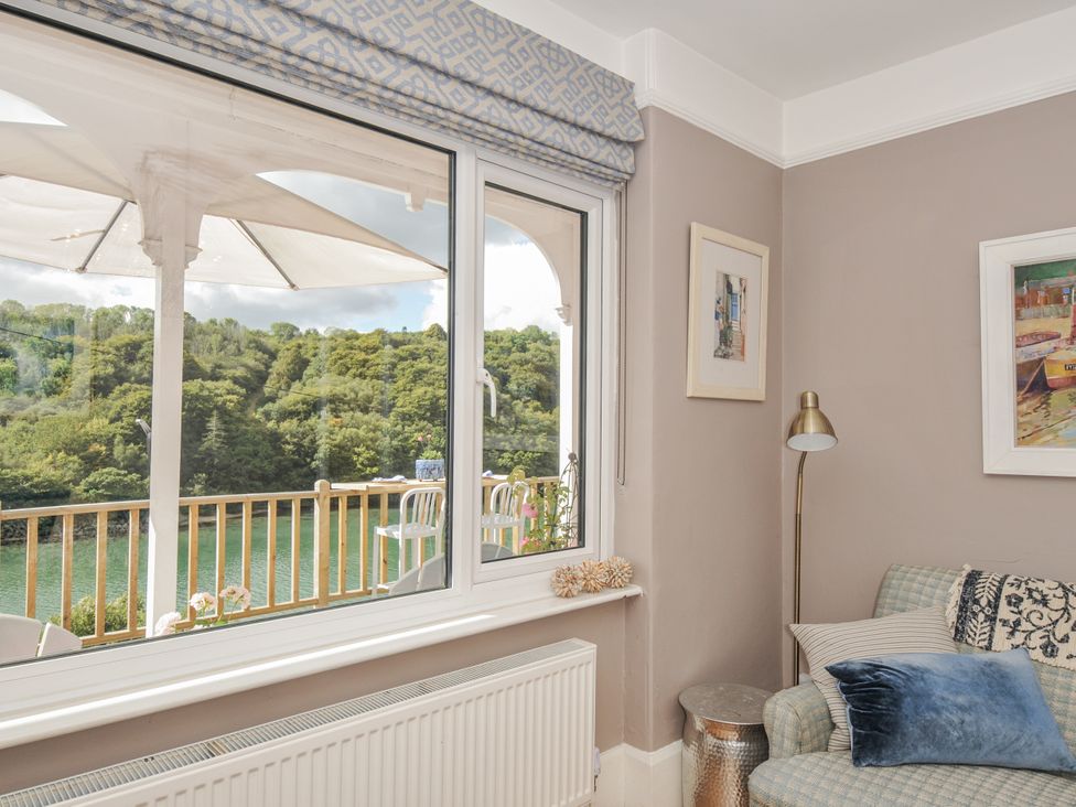 A living room with a view of the river at Mayhurst in Looe
