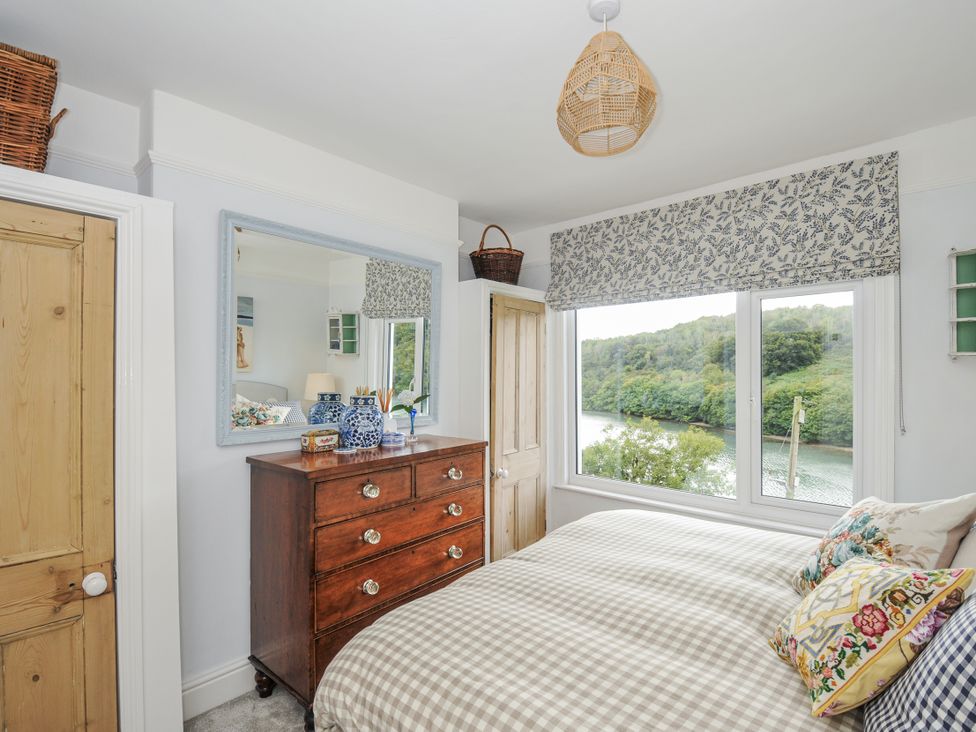 A bedroom with a bed and a dresser at Mayhurst Looe