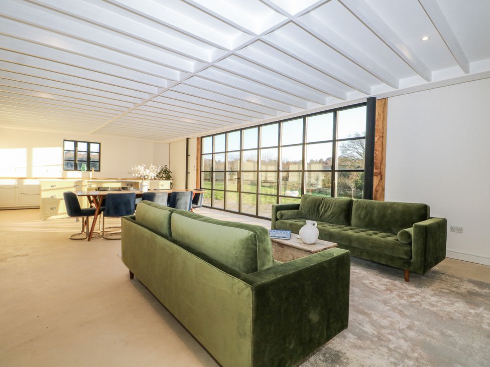 A living room with a green couch and table at Farm house in 