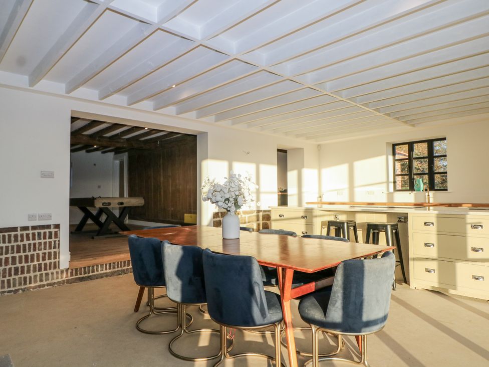 A dining room with a table and chairs at Farm house