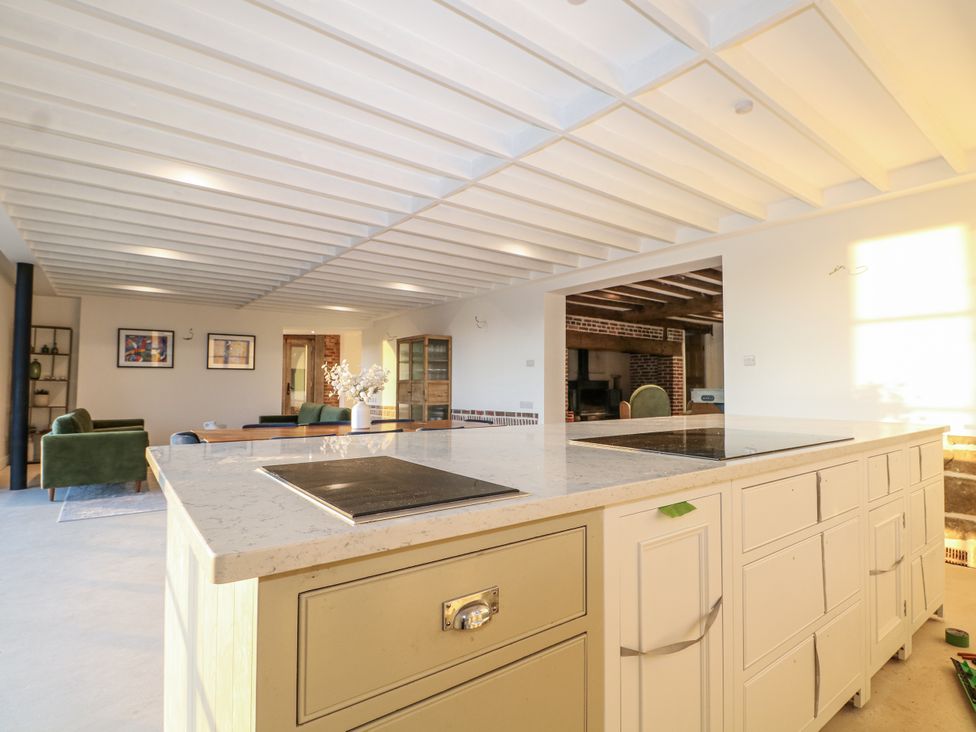 A kitchen with a kitchen island and seating at Farm house