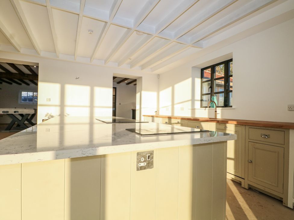 A kitchen with an island and cabinets at Farm house