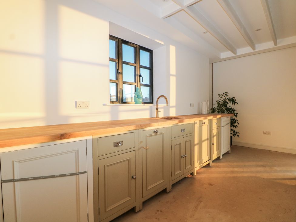 A kitchen with cabinetry and a sink at Farm house