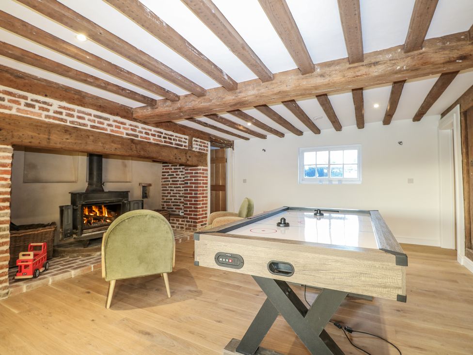 A games room with a fireplace and an air hockey table in a Farm house