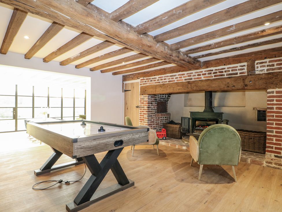A snug with an air hockey table and a fireplace at Farm house 