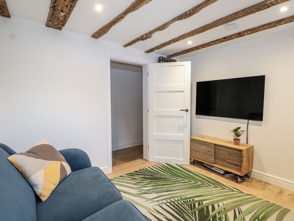 A living room with a sofa and television at Farm house