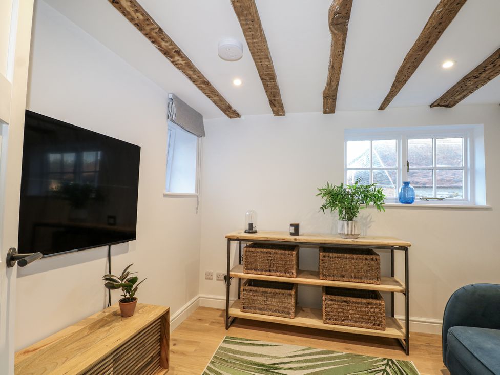 A living room with a television and shelf at the Farm house in 