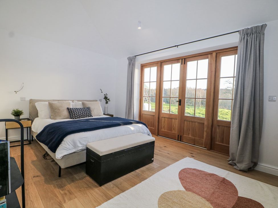 A bedroom with a bed and wooden doors at the Farm house
