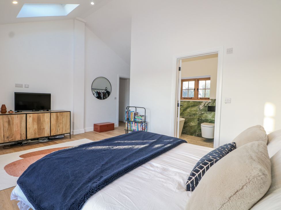 A bedroom with a bed and tv at Farm house location
