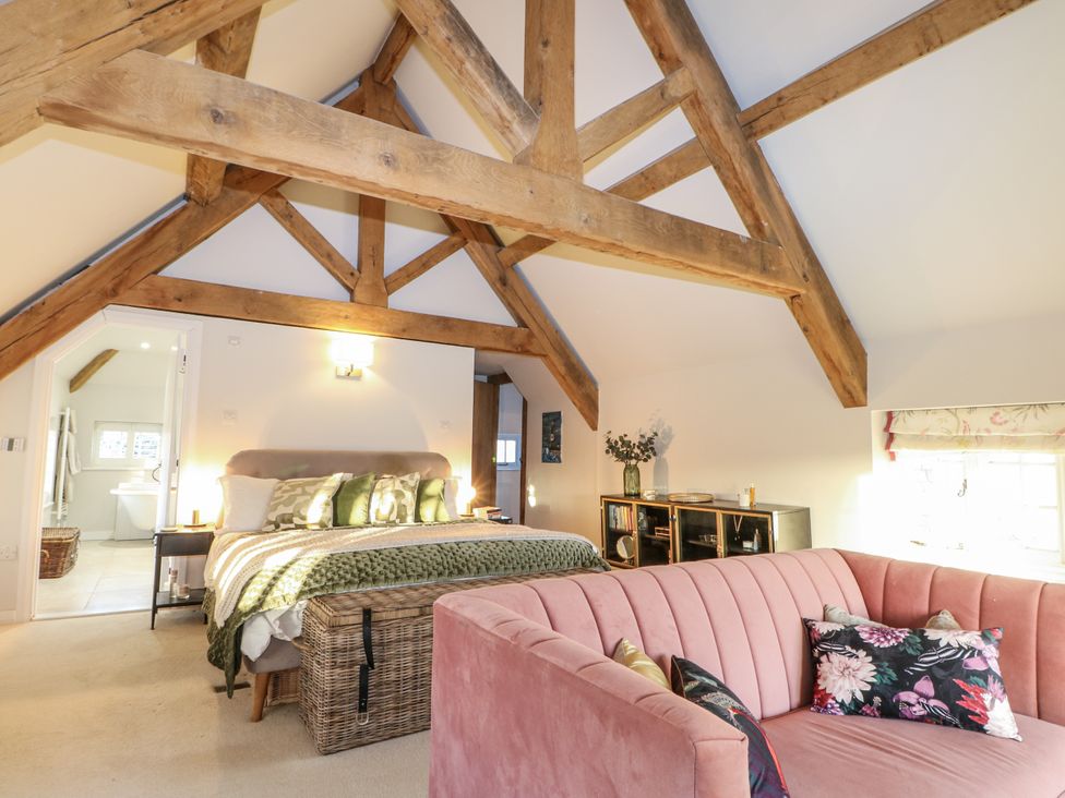 A bedroom with a bed and sofa at Farm house in 