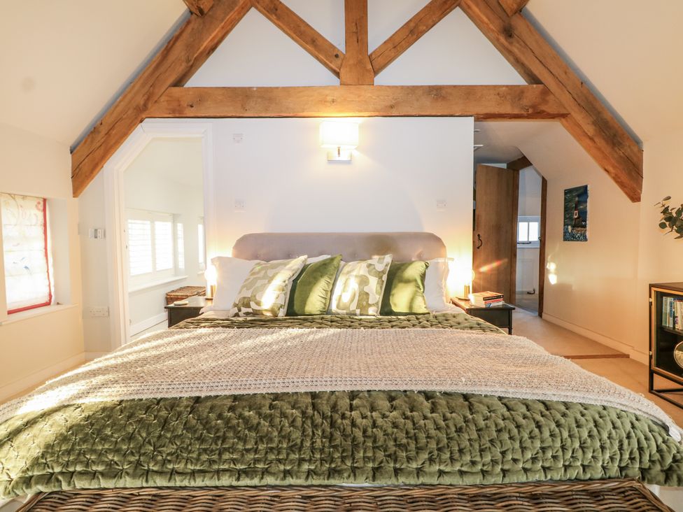 A bedroom with a bed and wooden beams at the Farm house