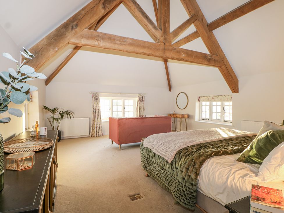 A bedroom with a large bed and a sofa at Farm house in 