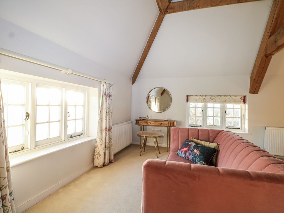 A living room with a sofa and a mirror at Farm house