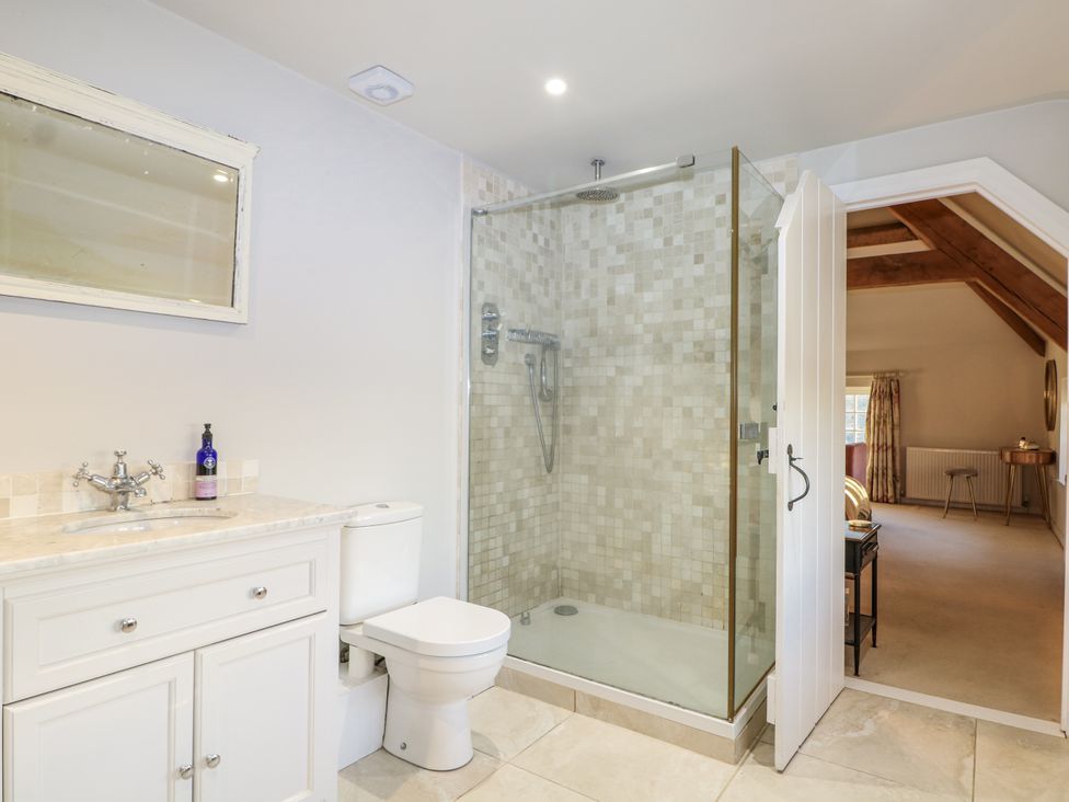 A bathroom with a shower, toilet, and sink at Farm house