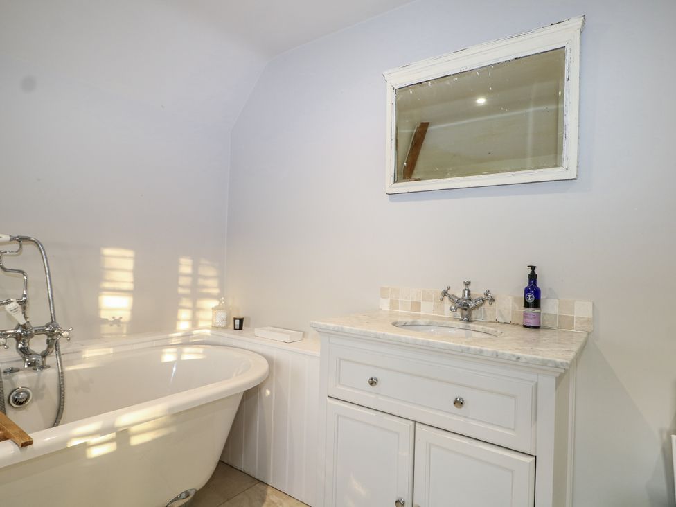 A bathroom with a bathtub and sink at Farm house