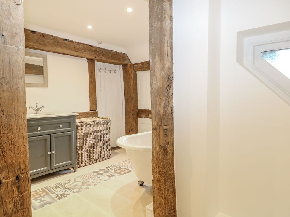 A bathroom with a bath tub and vanity at Farm house
