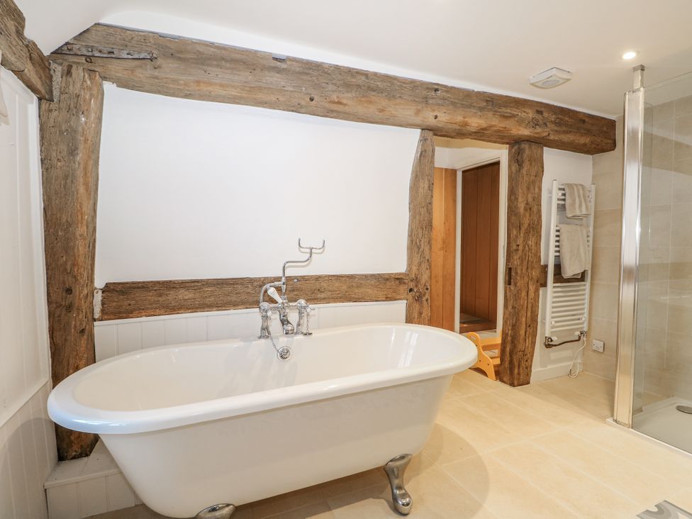 A bathroom with a bathtub and shower at Farm house 