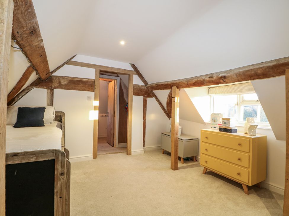 A bedroom with a bed and dresser at Farm house