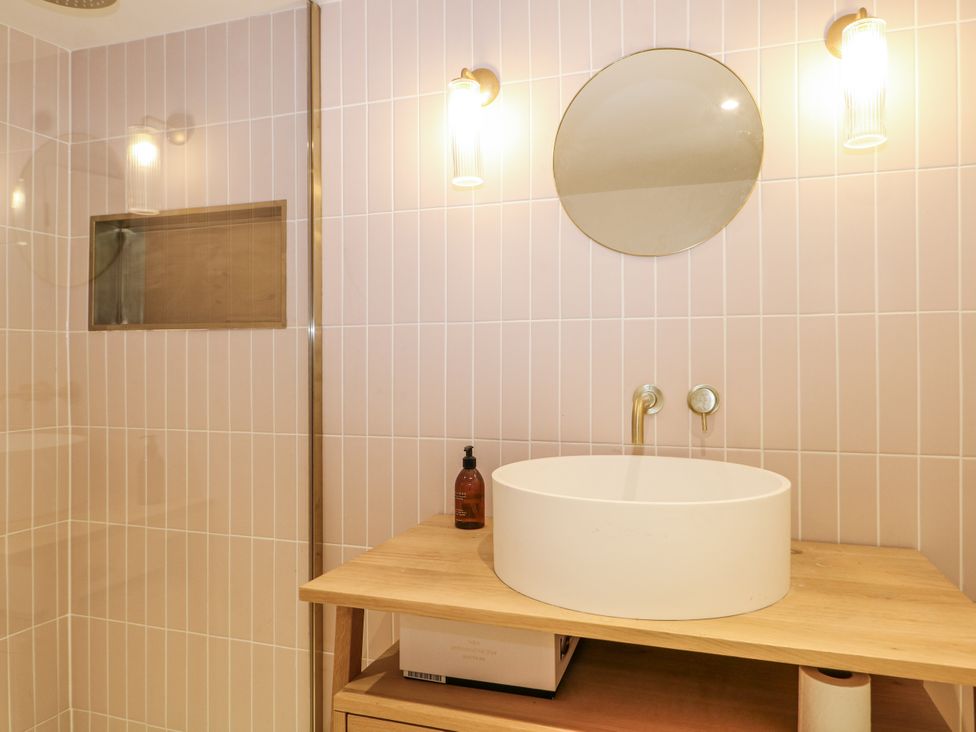 A bathroom with a sink and mirror at Farm house