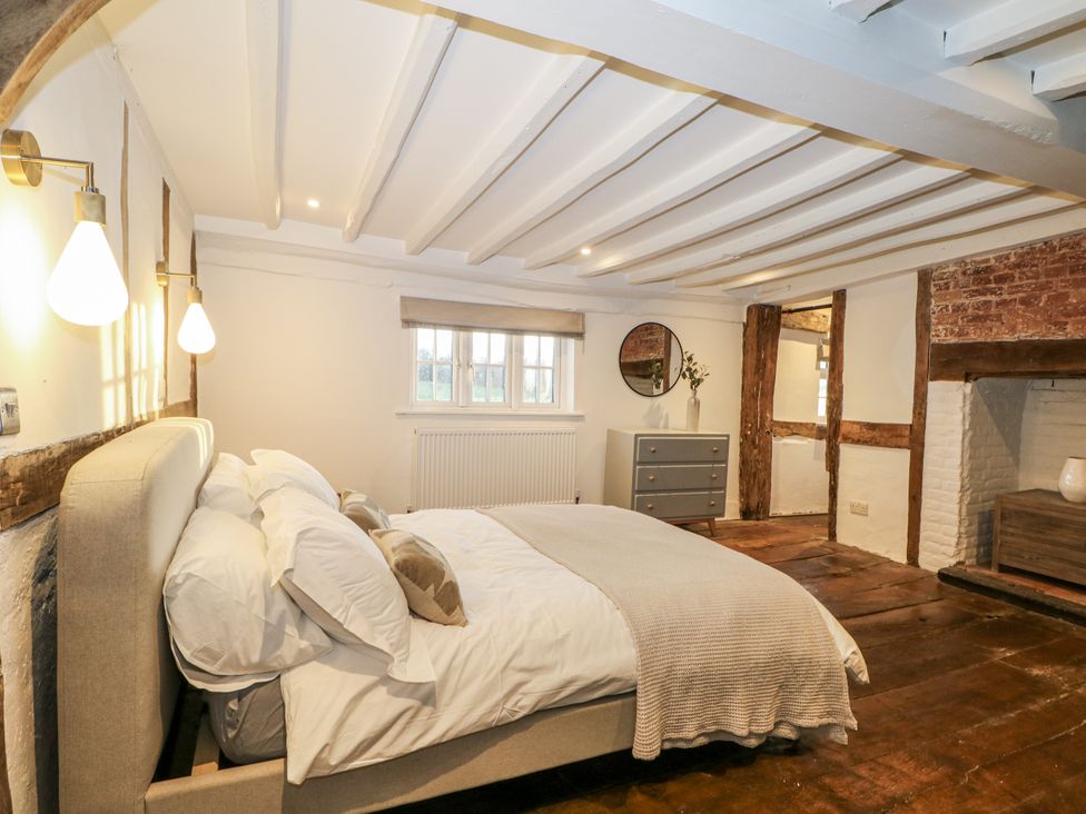 A bedroom with a bed and a dresser at Farm house