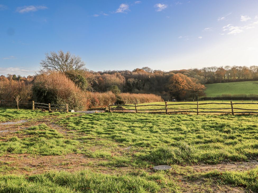 A field with trees and a fence at Farm house 
