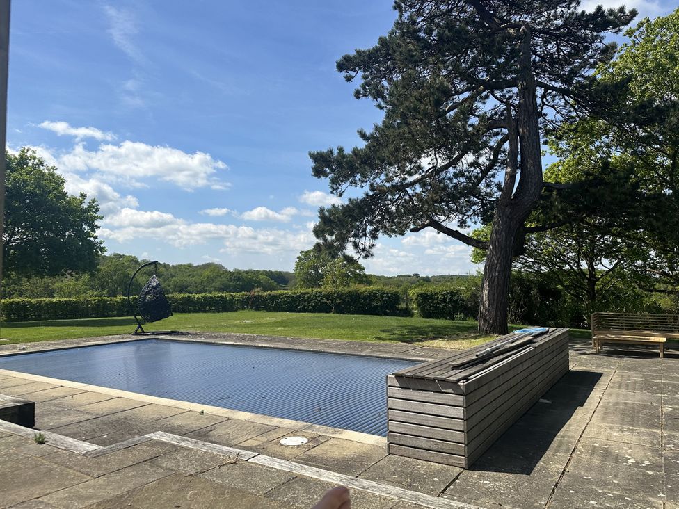 An outdoor area with a swimming pool and a tree at Farm house