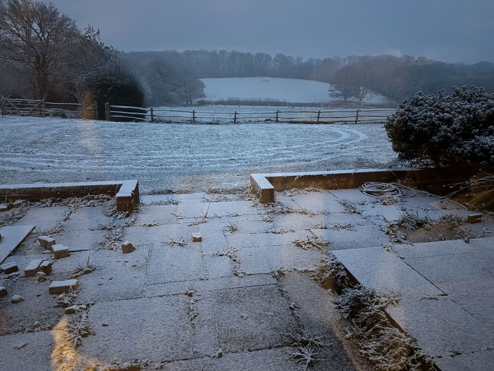 A snowy outdoor view from a house at Farm house