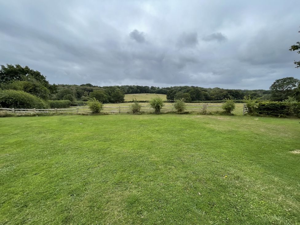 A view of a garden with grass and trees at the Farm house in 