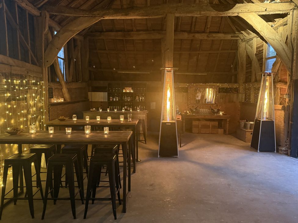 A barn with tables and lighting at Farm house in North Chailey