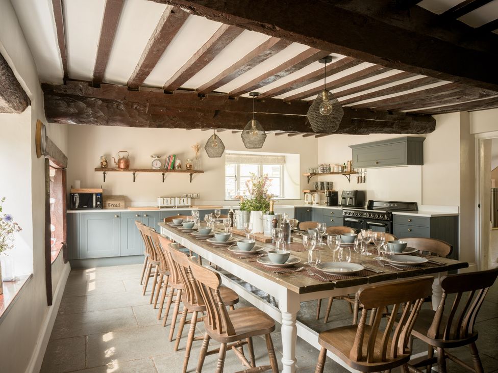 A dining room with a large table and chairs at Holwell Farmhouse in Bampton