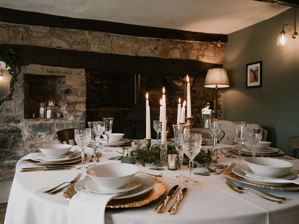 A dining room with table set for a meal at Holwell Farmhouse in Bampton