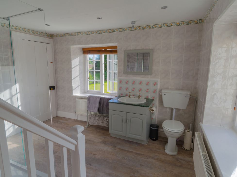 A bathroom with a sink and toilet at Badminton Farm Cottage in Acton Turville