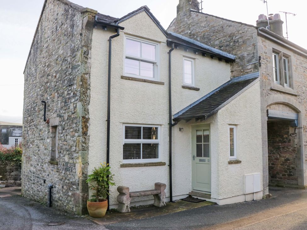 A house with a stone facade and a front door at 11 Tram Lane in Kirkby Lonsdale