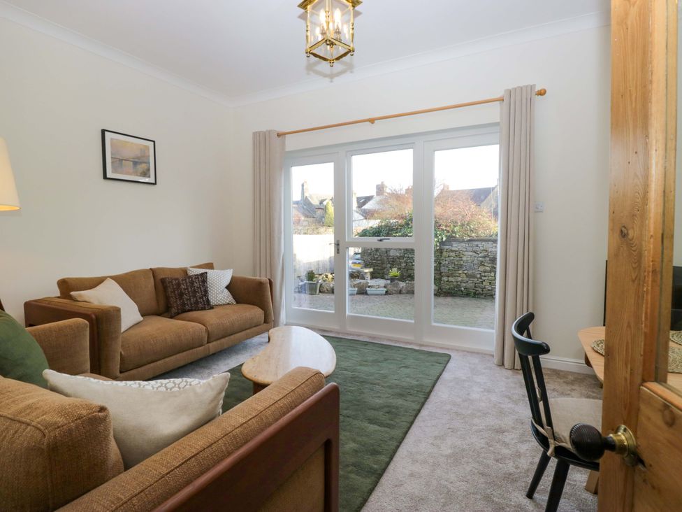 A living room with a sofa and coffee table at 11 Tram Lane, Kirkby Lonsdale